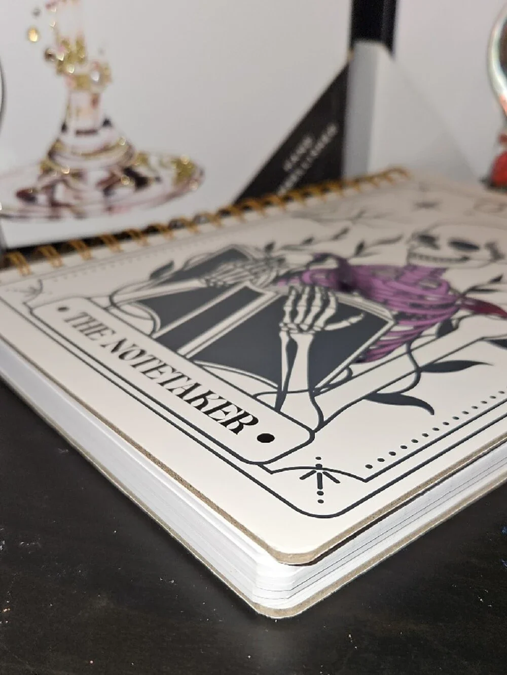 The Notetaker Spiral Notebook – White with Black & Purple Skeleton Design
